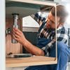 Plumber with drain cleaning sink